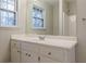 Bright bathroom featuring a white vanity, large mirror and shower at 50 Carriage Trce, Stockbridge, GA 30281