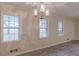 Dining area featuring a modern chandelier and bright windows for natural light at 50 Carriage Trce, Stockbridge, GA 30281