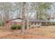 Attractive single-story home featuring brick accents, a covered carport, and mature trees at 50 Carriage Trce, Stockbridge, GA 30281