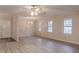 Bright living room with a modern ceiling fan, chandelier, and luxury vinyl plank flooring at 50 Carriage Trce, Stockbridge, GA 30281