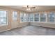 Bright sun room featuring many windows and luxury vinyl plank flooring at 50 Carriage Trce, Stockbridge, GA 30281