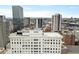 A multi-story building against a modern city skyline with views of tall buildings and the city at 57 Forsyth Nw St # 14D, Atlanta, GA 30303