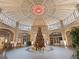 Expansive building lobby with a stunning domed ceiling and a decorated Christmas tree at 57 Forsyth Nw St # 14D, Atlanta, GA 30303