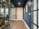 Hallway with herringbone floors and view of the glass enclosed wine cellar at 57 Forsyth Nw St # 14D, Atlanta, GA 30303