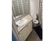 Bathroom with a white sink, granite countertop, toilet, and decorative shower curtain at 795 Hammond Dr # 1712, Atlanta, GA 30328