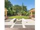 Community courtyard with a fire pit, benches, and decorative pergola structures at 795 Hammond Dr # 1712, Atlanta, GA 30328