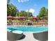 Relaxing community pool featuring lounge chairs and cabanas surrounded by lush greenery at 795 Hammond Dr # 1712, Atlanta, GA 30328