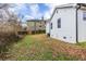 View of the backyard with a white home and partial fencing against blue skies and a few sparse trees at 1466 Venetian Sw Dr, Atlanta, GA 30311