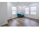 Bright room featuring hardwood floors, white walls and three large windows at 1466 Venetian Sw Dr, Atlanta, GA 30311
