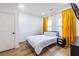 Bright bedroom with white walls, wood floors, and large windows with bright yellow curtains at 1466 Venetian Sw Dr, Atlanta, GA 30311