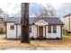 Beautifully renovated single-story home with crisp white siding, new roof and wood trim at 1466 Venetian Sw Dr, Atlanta, GA 30311