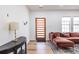 Cozy living room with wood floors, a modern sofa, and natural light from the windows at 1466 Venetian Sw Dr, Atlanta, GA 30311