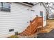 Exterior side view of home with wood staircase leading to a side entrance at 1466 Venetian Sw Dr, Atlanta, GA 30311
