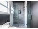 Stylish gray and white tiled shower with built-in shelving and sleek glass door at 1466 Venetian Sw Dr, Atlanta, GA 30311