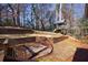 The tiered backyard features a charming treehouse with slide and a wooden retaining wall for added visual appeal at 3044 Windfield Cir, Tucker, GA 30084