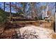 Large backyard featuring a wooden deck and a custom treehouse, offering an outdoor space for entertainment and relaxation at 3044 Windfield Cir, Tucker, GA 30084