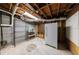 Unfinished basement with shelving, fridge, and concrete flooring at 3044 Windfield Cir, Tucker, GA 30084