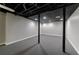 Spacious finished basement featuring gray carpet, modern lighting, and painted ceiling at 3044 Windfield Cir, Tucker, GA 30084