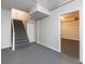 Basement stairs leading to a finished room with gray carpet flooring at 3044 Windfield Cir, Tucker, GA 30084