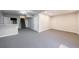 Partially finished basement with bar, stairs to upper level, neutral walls, and carpet at 3044 Windfield Cir, Tucker, GA 30084