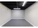 Clean, unfinished basement with modern lighting and gray carpet at 3044 Windfield Cir, Tucker, GA 30084