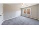 A large secondary bedroom with neutral gray walls, carpet, and natural lighting at 3044 Windfield Cir, Tucker, GA 30084