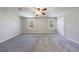Large bedroom with neutral walls, carpet, a ceiling fan, and natural light from two windows at 3044 Windfield Cir, Tucker, GA 30084