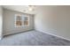 This bedroom has plush carpeting, double-paned windows, and neutral decor at 3044 Windfield Cir, Tucker, GA 30084