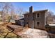 The back exterior of the home features a spacious deck, neutral paint, a large chimney and a partially fenced yard at 3044 Windfield Cir, Tucker, GA 30084
