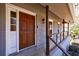 Inviting front porch featuring a beautiful wood door, brickwork, and cable railing at 3044 Windfield Cir, Tucker, GA 30084