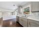 Kitchen with gray cabinets, stainless steel appliances, white countertops and backsplash, and wooden floors at 3044 Windfield Cir, Tucker, GA 30084