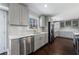 Modern kitchen featuring stainless steel appliances, gray cabinets, and a stylish backsplash at 3044 Windfield Cir, Tucker, GA 30084