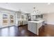 Kitchen with stainless steel appliances, gray cabinets, island, hardwood floors, and nearby patio access at 3044 Windfield Cir, Tucker, GA 30084