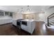 Open kitchen with stainless steel appliances, gray cabinets, an island with cooktop and oven, and modern lighting at 3044 Windfield Cir, Tucker, GA 30084