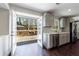 Modern kitchen with gray cabinets, stainless steel appliances and deck access at 3044 Windfield Cir, Tucker, GA 30084
