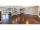 Spacious living room with hardwood floors and a kitchen in background at 3044 Windfield Cir, Tucker, GA 30084