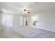Spacious main bedroom with neutral gray walls, carpet, ceiling fan, and entrance to en suite bathroom at 3044 Windfield Cir, Tucker, GA 30084