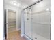Large glass shower with tile surround and adjacent walk-in closet with custom shelving at 3044 Windfield Cir, Tucker, GA 30084