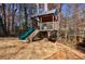 A custom treehouse with a slide, nestled among mature trees, offers a playful retreat in this property's backyard at 3044 Windfield Cir, Tucker, GA 30084