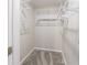 A bright and airy walk-in closet has wall mounted adjustable shelving at 3044 Windfield Cir, Tucker, GA 30084