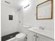 Modern bathroom with subway tile, black honeycomb floor in shower, and vanity with a mirror at 3648 Garrison Sw Dr, Atlanta, GA 30331