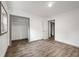 Bedroom featuring wood-look floors, a closet for ample storage, and a neutral color scheme at 3648 Garrison Sw Dr, Atlanta, GA 30331