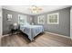Bedroom with windows, light grey walls, and wood flooring at 3648 Garrison Sw Dr, Atlanta, GA 30331