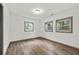 Inviting bedroom with three windows for natural light and wood-look floors at 3648 Garrison Sw Dr, Atlanta, GA 30331