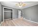 Bright bedroom features wood-look floors, gray walls, and a closet for ample storage at 3648 Garrison Sw Dr, Atlanta, GA 30331