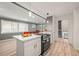 Bright kitchen with an island and white cabinets that opens up to a living space at 3648 Garrison Sw Dr, Atlanta, GA 30331
