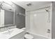 Clean bathroom with white vanity, a tiled backsplash, and a shower-tub combo at 725 Dalrymple Rd # 2E, Atlanta, GA 30328