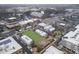 An aerial view highlights a commercial district with a landscaped town square, street parking and surrounding architecture at 145 Rose Garden Ln, Alpharetta, GA 30009