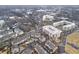 An aerial view showcases the neighborhood with townhouses, apartments, and commercial buildings in a densely populated urban setting at 145 Rose Garden Ln, Alpharetta, GA 30009