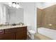 A clean bathroom featuring a vanity with granite countertop and a tiled shower over tub at 145 Rose Garden Ln, Alpharetta, GA 30009